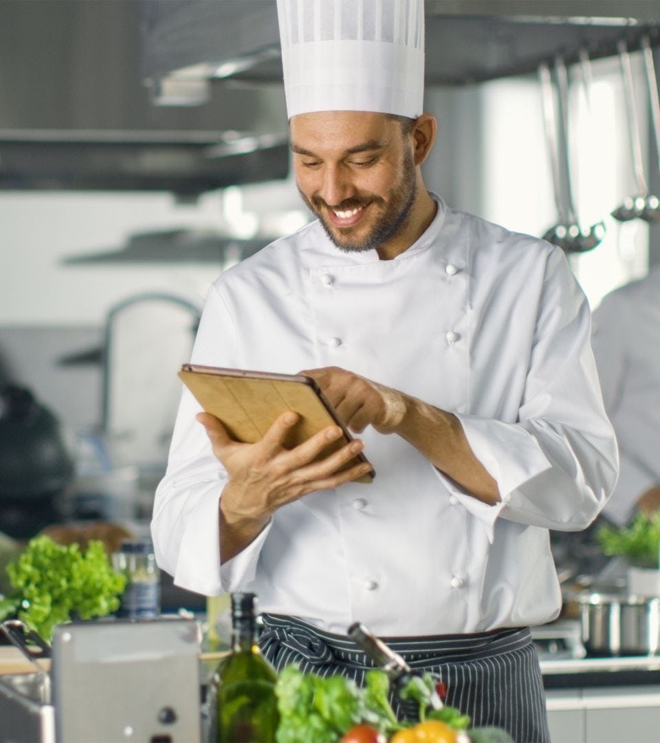 smiling cook with tablet